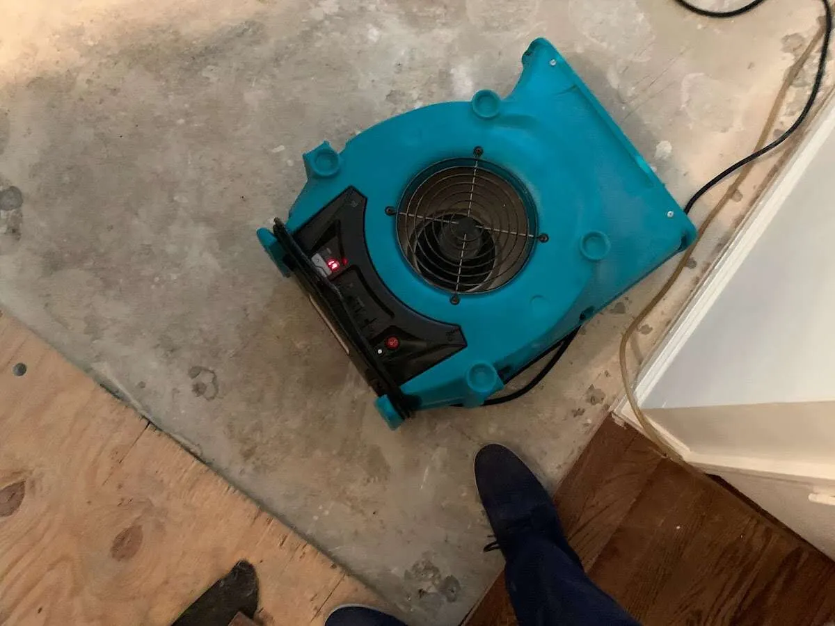 Air mover drying subfloor during Leak Detection & Repair in Indiana